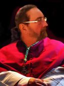 Monseigneur Antonio ZOLO (Frère d‘Émile ZOLO reporter.) Évêque-Garagiste, attaché aux déplacements des camériers secrets surnuméraires du Saint-Graal.